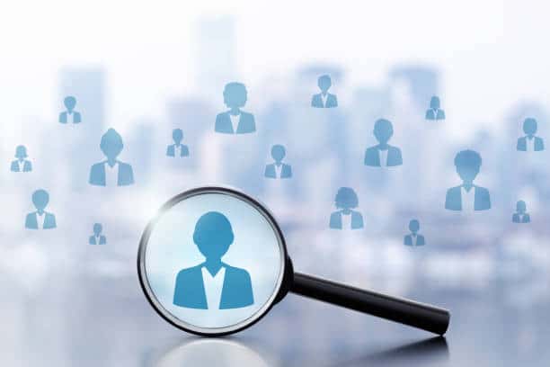 Magnifier and people icons on cityscape background.